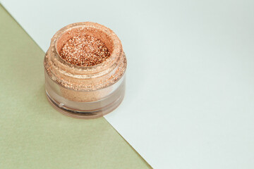 Gold glitter makeup isolated and open on green and white background