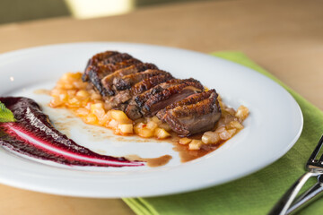 orange duck meal on the side. White plate.