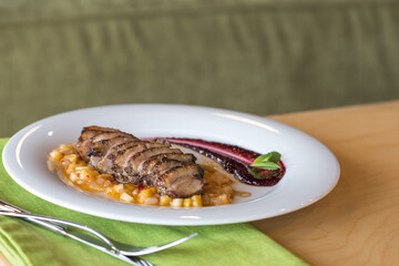 orange duck meal on the side. White plate.