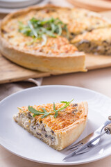 Traditional French Quiche with cheese, spinach and chicken. Quiche lorraine. French cuisine. Top view. Light wooden background