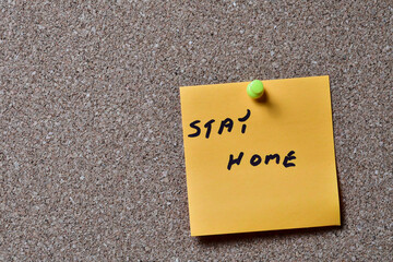 Stay at home.  Information messages written on yellow paper and posted to a cork board.