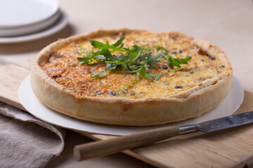Traditional French Quiche with cheese, spinach and chicken. Quiche lorraine. French cuisine. Top view. Light wooden background