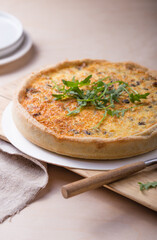 Traditional French Quiche with cheese, spinach and chicken. Quiche lorraine. French cuisine. Top view. Light wooden background