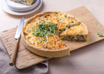 Traditional French Quiche with cheese, spinach and chicken. Quiche lorraine. French cuisine. Top view. Light wooden background