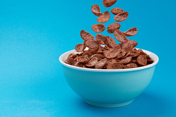 Falling chocolate corn flakes, healthy breakfast