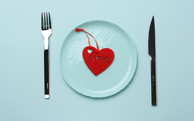 red heart lies in a blue round ceramic plate