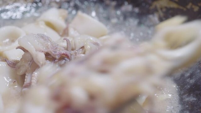 Squit get stir-fried in a pan with garlic and oil. Seafood and asian menu. 