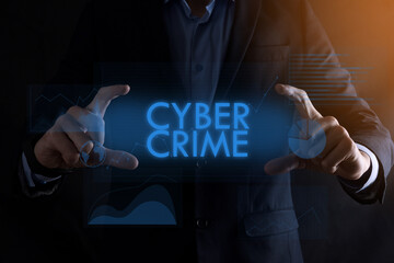 Business man hands holding inscription CYBER CRIME with different graphs on the background.automation technology concept
