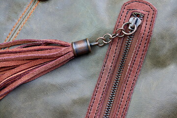 
A tightly closed zipper secures two layers of faux leather. Zippered metal slider with faux...