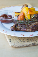 grilled steak grilled on a wooden background, with spices. grill strips visible on steak