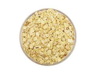 Oat flakes in glass bowl isolated on white background, top view