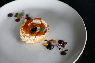 Chocolate dessert cake with berry sauce and almond with decorated