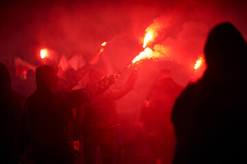 flaming red flare during a street protest in the city