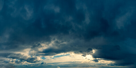 Fantastic dark blue thunderclouds at sunrise, natural composition