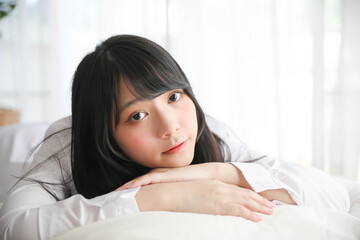 Portrait beautiful asian girl sleeping on bed in white room