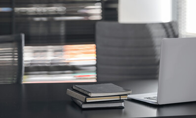 Mockup laptop computer on black top table in modern office.