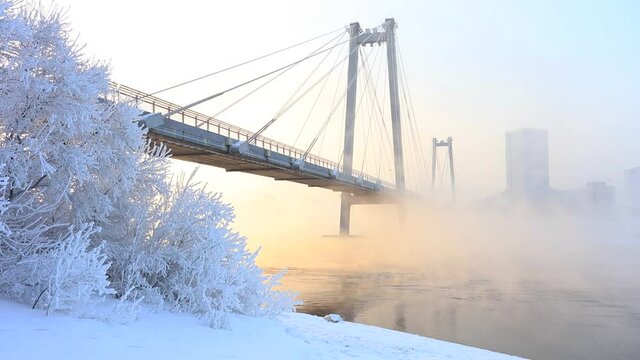 Bridge over the river in the winter season. Beautiful city view. The first ice on the river in the city
