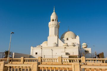 Fototapeta na wymiar A white Al Rahmah mosque located at Jeddah Corniche, 30 km coastal resort area of Jeddah city with coastal road, recreation areas, pavilions and civic sculptures in Jeddah, Saudi Arabia