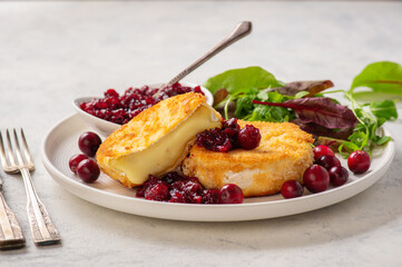 Fried camembert cheese and cranberry sauce.