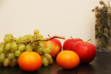 Fresh fruits on the kitchen black table. Healthy food from fresh fruits.