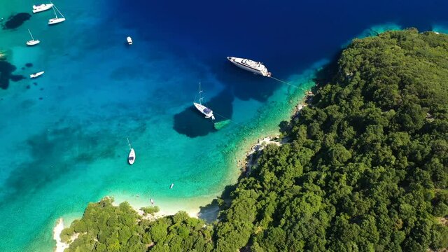 Aerial drone video of turquoise paradise sandy beach and bay of Filatro a safe sail boat anchorage in Ithaki or Ithaca island, Ionian, Greece