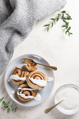 Cinnamon rolls or cinnabon  with icing for Christmas. Homemade traditional winter festive dessert buns. Pastry food for breakfast on white background