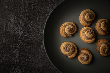 Still life with baked double-layered spiral cookies on plate