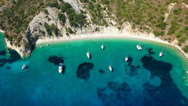 Aerial drone video of turquoise paradise sandy beach and bay of Filatro a safe sail boat anchorage in Ithaki or Ithaca island, Ionian, Greece