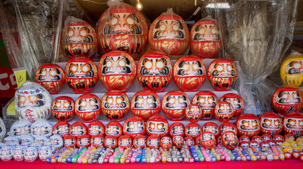 Daruma Doll with various size sold in a stall, Daruma is a traditional doll from Japan