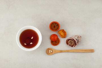 Sujeonggwa- Korean cold fruit tea or chilled punch on marble surface, top view. It is made from...
