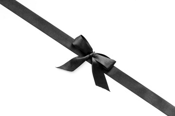 Black ribbon with bow isolated on white. Top view, copy space