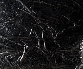 texture of dark crumpled polyethylene background