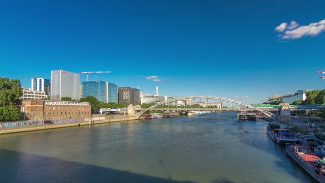The Austerlitz viaduct in Paris timelapse hyperlapse, seen from bridge over the river Seine with a metro train passing, is a single-deck, steel arch, rail bridge that was built in 1904