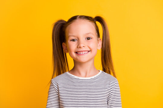 Photo of happy cute sweet little girl happy beaming smile isolated on bright shine yellow color background
