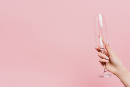 Cropped View Of Woman Holding Empty Champagne Glass Isolated On Pink