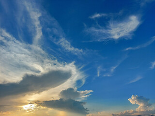 sky and cloudsA beautiful photograph of the sky with white fluffy clouds alternating with the golden sun shining.