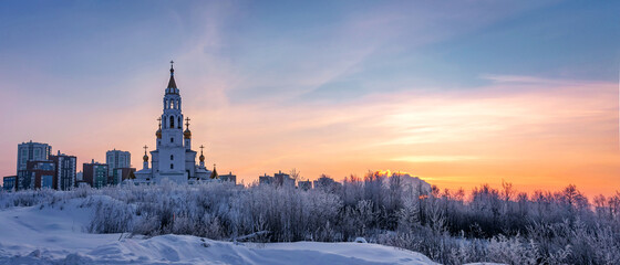 Church of the saints and God's builders at sunrise against the backdrop of a clear sky and withered grass