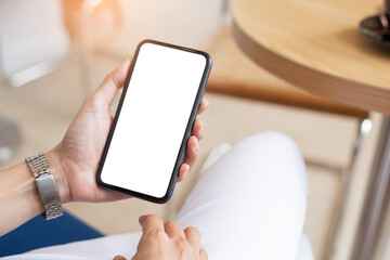 cell phone blank white screen mockup.woman hand holding texting using mobile on desk at office.background empty space for advertise.work people contact marketing business,technology