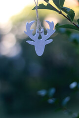 Reindeer Christmas ornament hanging in the garden. Selective focus..