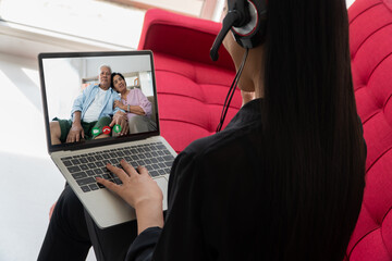 Asian parents are video conference with daughter during vacation. Concept of communication technology