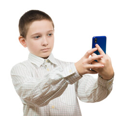 boy in a shirt takes a selfie on a smartphone on a white background