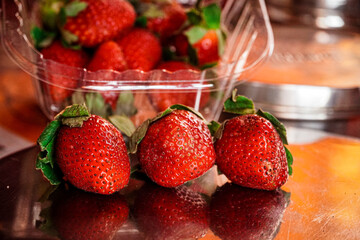 Picture of 3 strawberries with background of strawberries too. Strawberry picture.