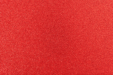 Shiny surface. Red glitter texture. Christmas abstract background, defocused