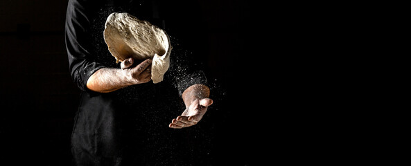 male hands making dough for pizza with flour scattering. banner, menu, recipe, place for text - obrazy, fototapety, plakaty
