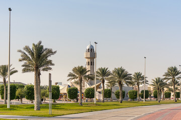 A common small mosque with palm tree in the Dammam Corniche coastal park in Dammam, Kingdom of Saudi Arabia
