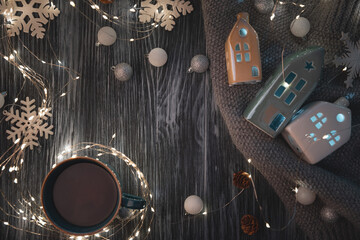 Hot Christmas tea against decorations on wooden table. Top view. New Year or Christmas celebration concept