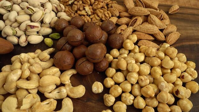 Assorted nuts on a wooden board.