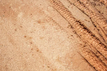 Deurstickers closeup tire tracks marks of motorcross on the soil. top view. flat lay © memorystockphoto