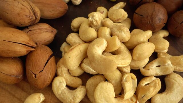 Assorted nuts on a wooden board.