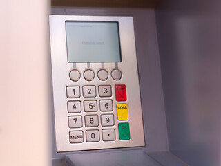 Side view of ATM numeric silver metal key pad.